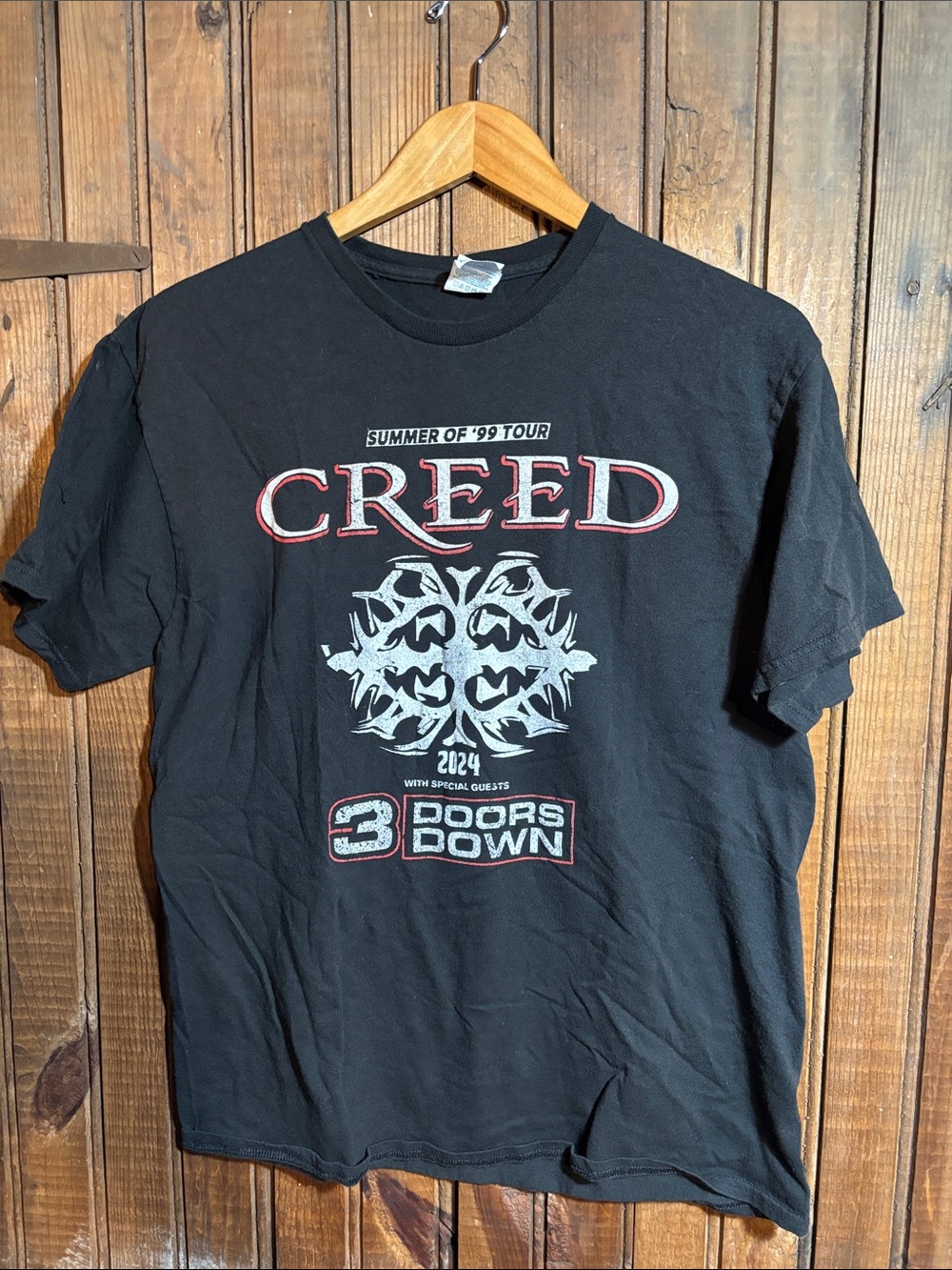 Delta Black Short-Sleeve Creed Tour Graphic Tee with White and Red Print